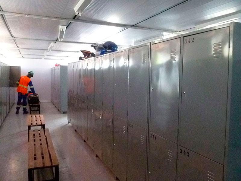 Vestiário amplo com bancos e armários de ambos os lados